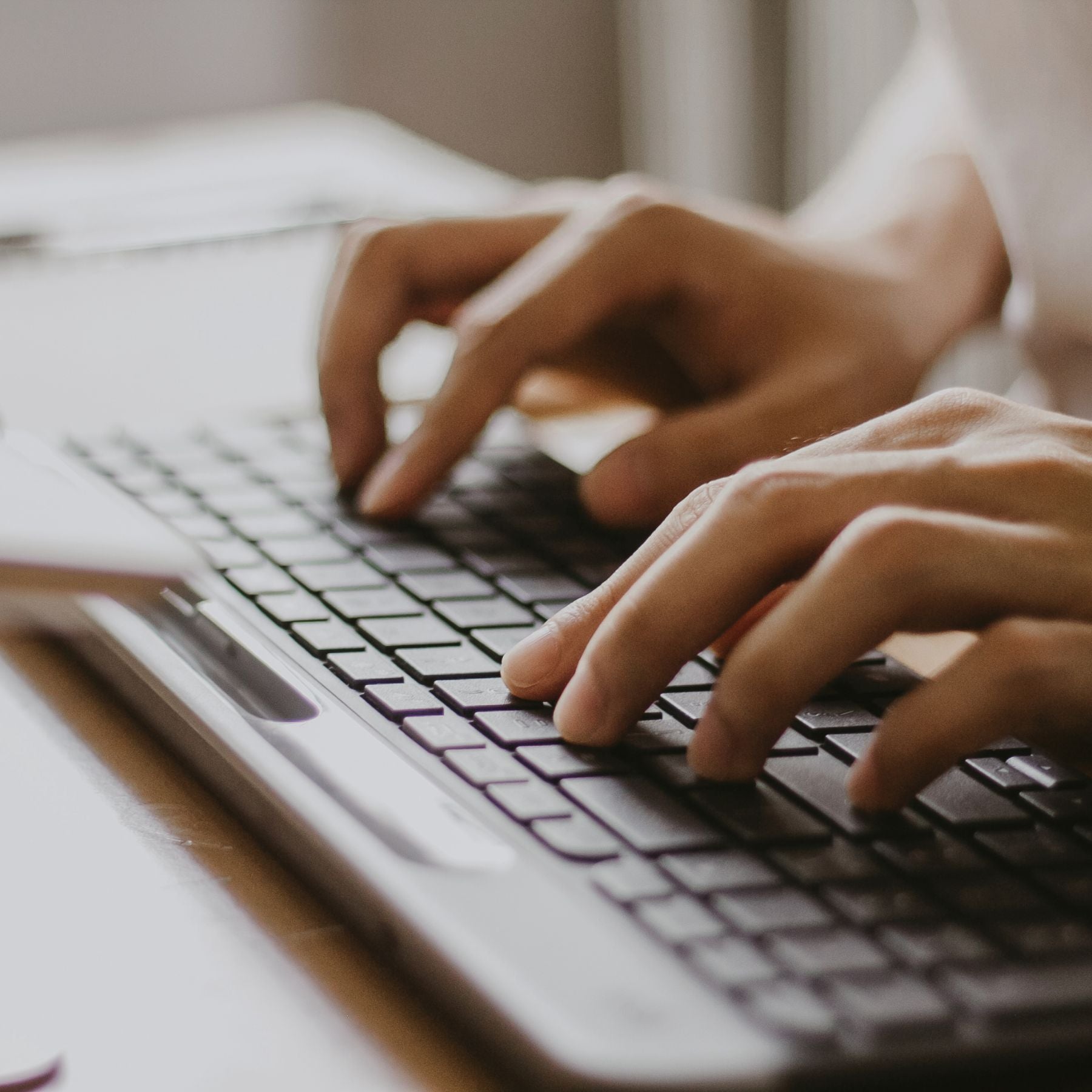 Designer typing on computer